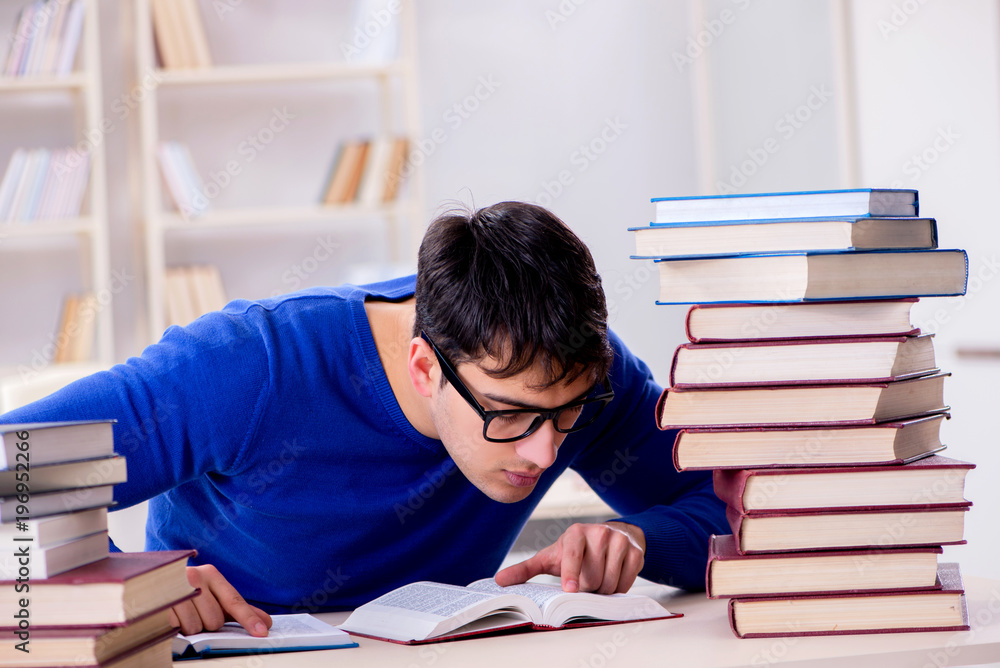 Male student preparing for exams in college library Male student preparing for exams in college library