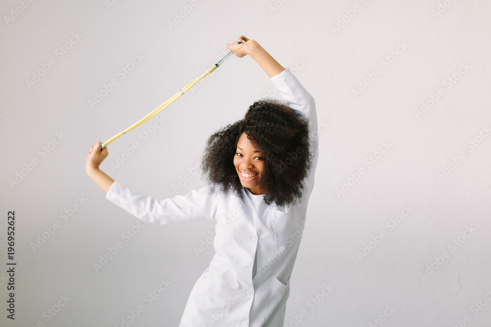 An African American female medical doctor with a stethoscope in hospital on white background An African American female medical doctor with a stethoscope in hospital on white background