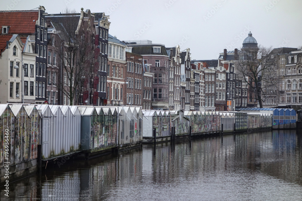 Dec 20, 2017 - The Bloemenmarkt Floating Flower Market, Singel canal and Historic Dutch style houses in Amsterdam, Netherlands