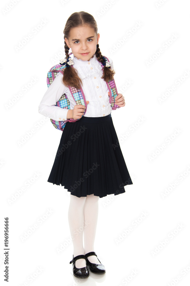 Beautiful schoolgirl with a backpack behind her shoulders. Beautiful schoolgirl with a backpack behind her shoulders.