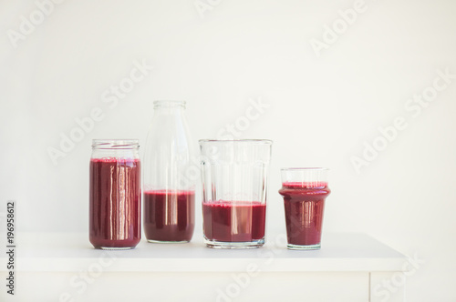 Fresh morning beetroot smoothie or juice in glasses, white background, copy space. Healthy vegan or vegetarian breakfast, seasonal detox, clean eating, alcaline diet, weight loss food concept