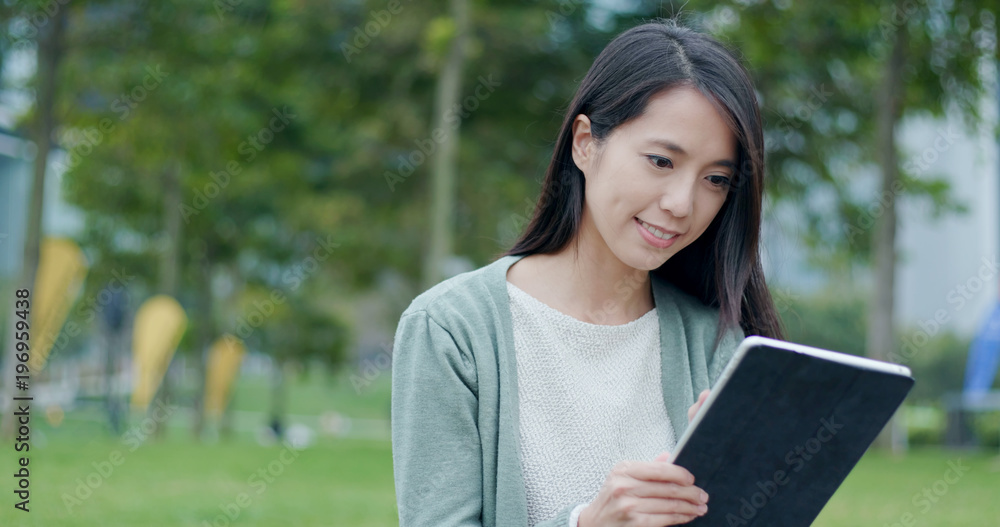 Fototapeta premium Woman working on tablet at outdoor