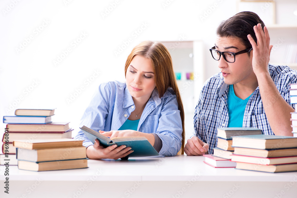 Pair of students studying for university exams Pair of students studying for university exams