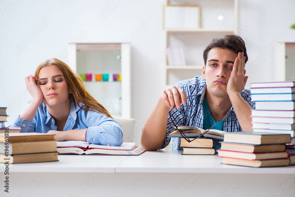 Pair of students studying for university exams Pair of students studying for university exams