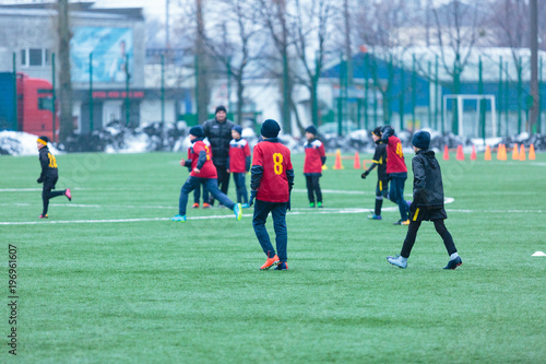 boys play football on the winter stadium © Natali