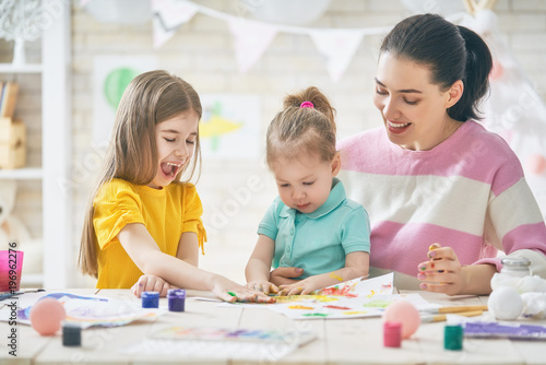 Mother and daughters painting together