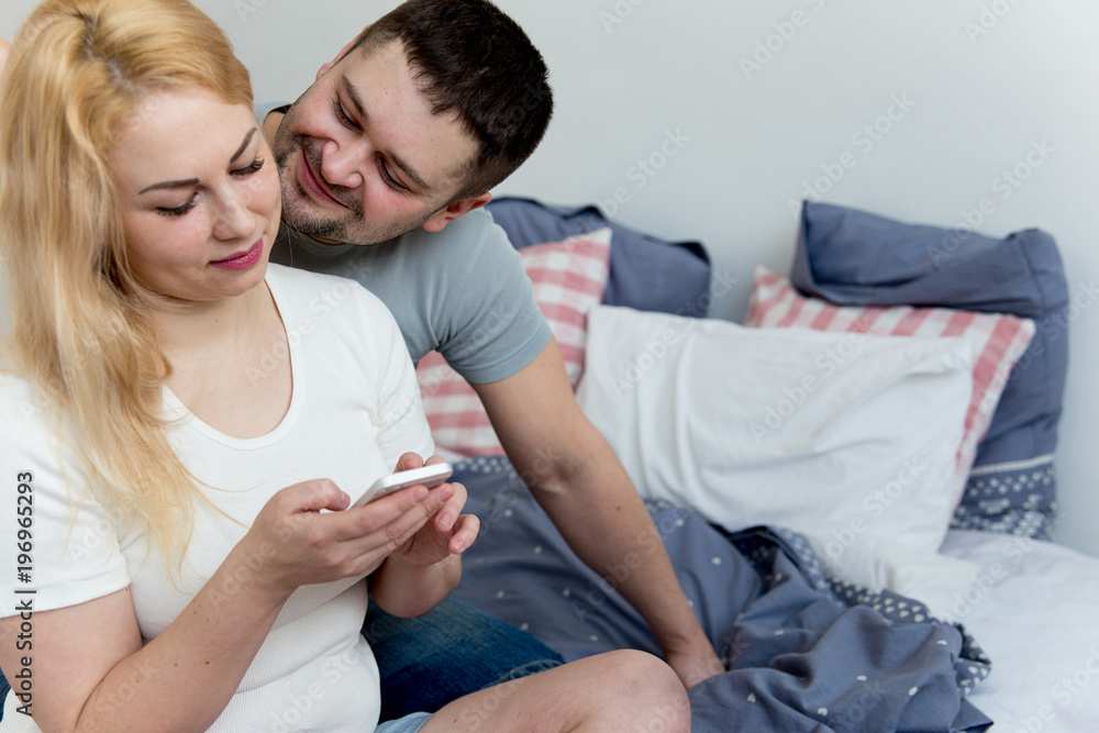 Couple using smatrphone in bed Couple using smatrphone in bed