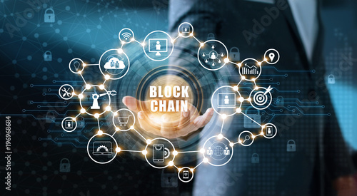 Blockchain technology and network concept. Businessman holding text blockchain in hand with icons network connection on blue security  and digital connection background photo