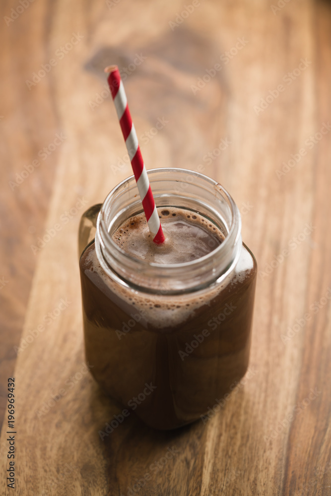 warm cocoa in jar mug on a wooden table warm cocoa in jar mug on a wooden table