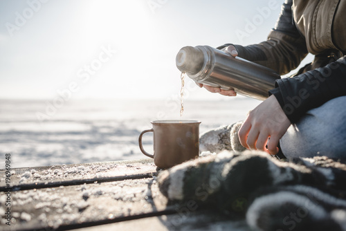 Pouring the tea from the thermos