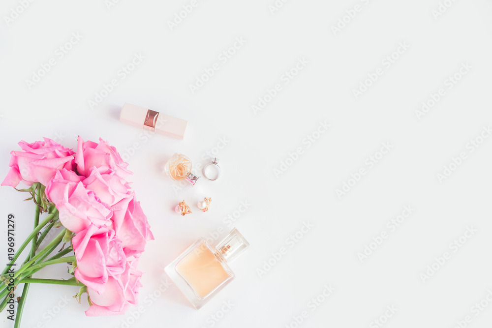 Bouquet of pink roses and women's accessories on white background Bouquet of pink roses and women's accessories on white background