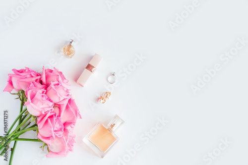Bouquet of pink roses and women's accessories on white background
