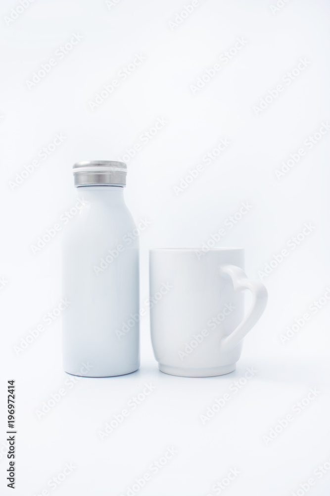 White cup with a white thermo bottle on a white background White cup with a white thermo bottle on a white background