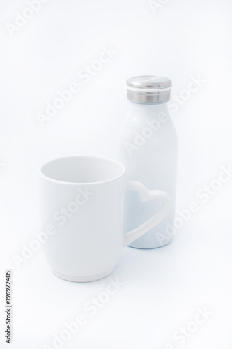 White cup with a white thermo bottle on a white background