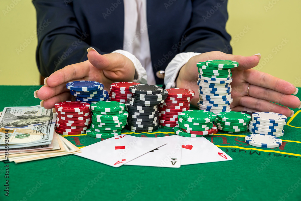 female hands reaching for poker chips, play card in casino female hands reaching for poker chips, play card in casino