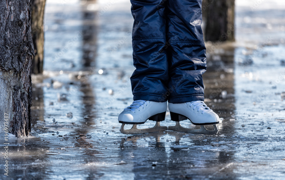 Female ice skates on the ice in the park Female ice skates on the ice in the park