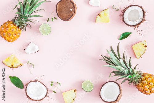 Summer fruit composition. Pineapples, coconuts on pink background. Fruit background. Summer concept. Flat lay, top view, copy space