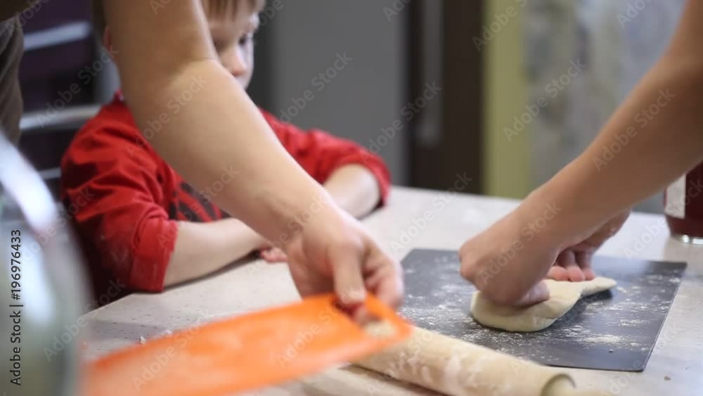 children's hands prepare pizza. spread the filling on the dough. children's hands prepare pizza. spread the filling on the dough.