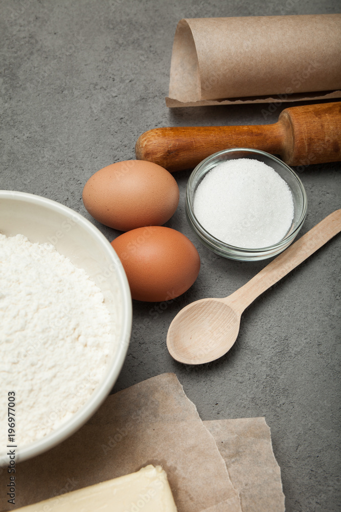 Wheat flour in bowl, milk in a glass jar, chicken eggs - vertical. Wheat flour in bowl, milk in a glass jar, chicken eggs - vertical.