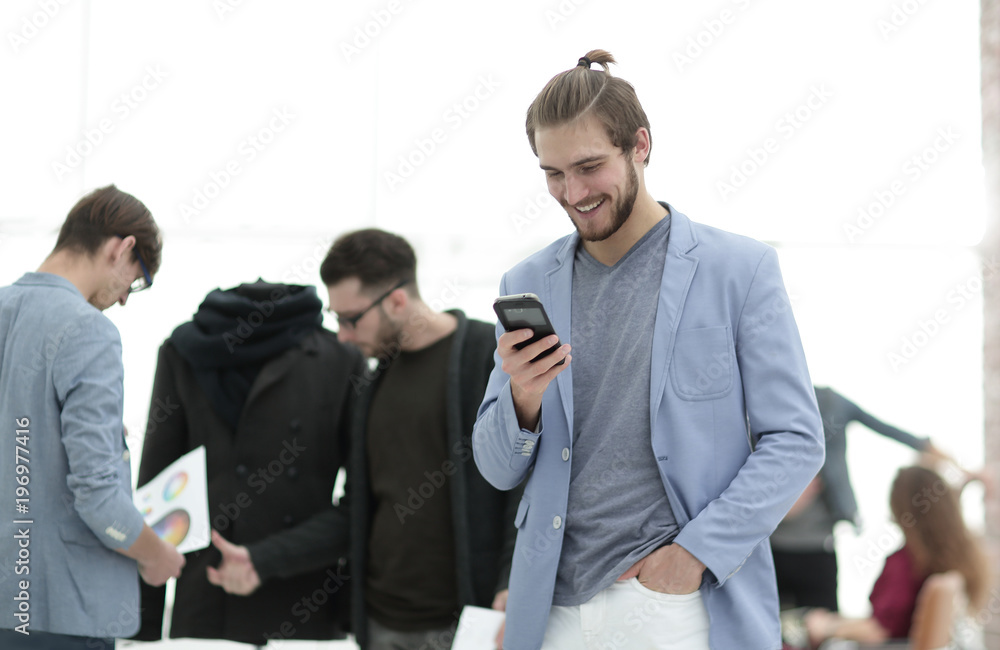 designer with mobile phone on background creative Studio designer with mobile phone on background creative Studio
