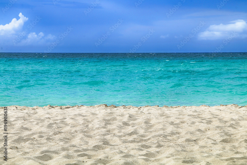 Summer landscape: Sandy beach, ocean and blue sky Summer landscape: Sandy beach, ocean and blue sky