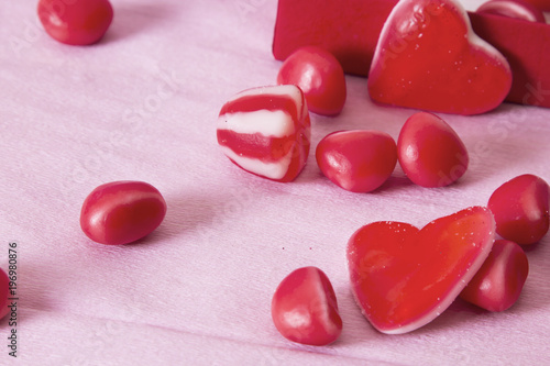 gift box with heart candies on pink background