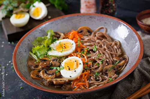 Japanese miso ramen noodles with eggs, carrot and mushrooms. Soup delicious food.