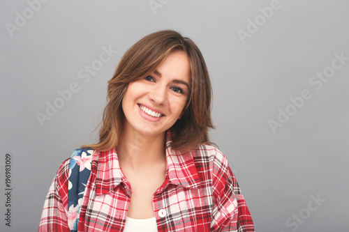 Portrait of young student woman in t-shirt and backpack.