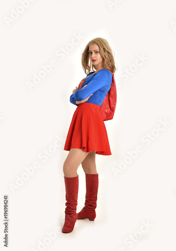 Платно full length portrait of pretty girl wearing super hero costume, standing pose, isolated on white studio background
