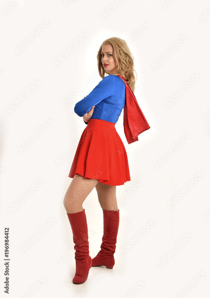 full length portrait of pretty girl wearing super hero costume, standing pose, isolated on white studio background. full length portrait of pretty girl wearing super hero costume, standing pose, isolated on white studio background.