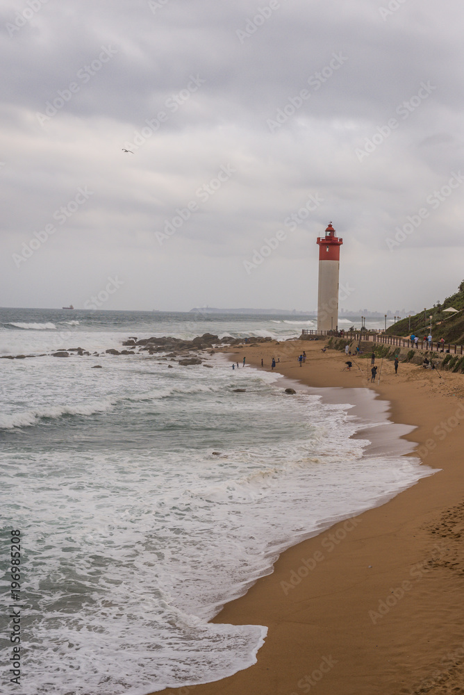 Fototapeta premium Beach with Lighthouse in Background