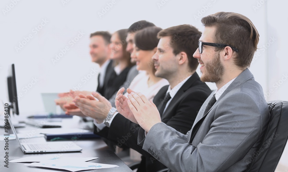 cheering business team sitting at Desk cheering business team sitting at Desk