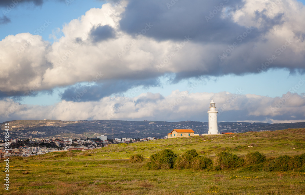 Bright beautiful scenery, an old lighthouse on the shore of the Mediterranean Sea, Cyprus, Paphos. A popular destination for summer holidays and vacations