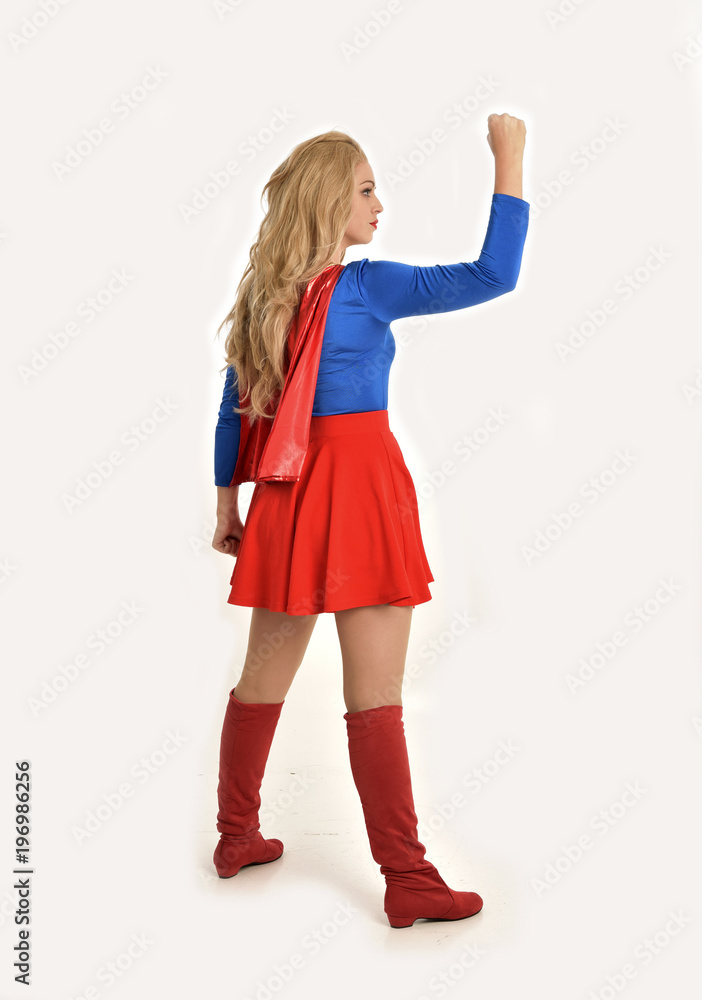 full length portrait of pretty girl wearing super hero costume, standing pose, isolated on white studio background. full length portrait of pretty girl wearing super hero costume, standing pose, isolated on white studio background.