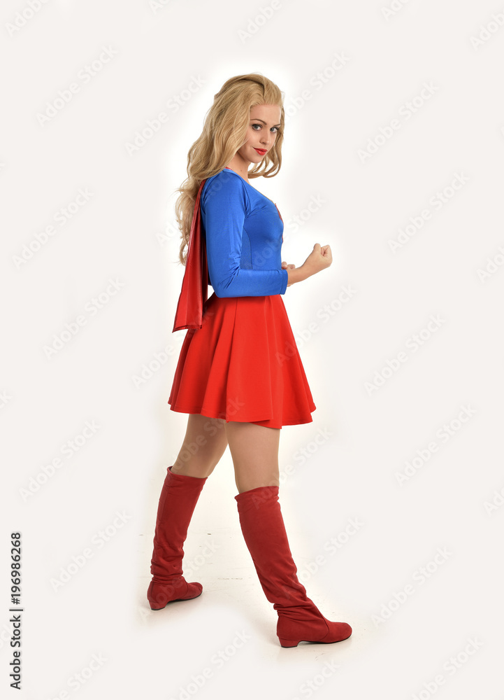 full length portrait of pretty girl wearing super hero costume, standing pose, isolated on white studio background. full length portrait of pretty girl wearing super hero costume, standing pose, isolated on white studio background.