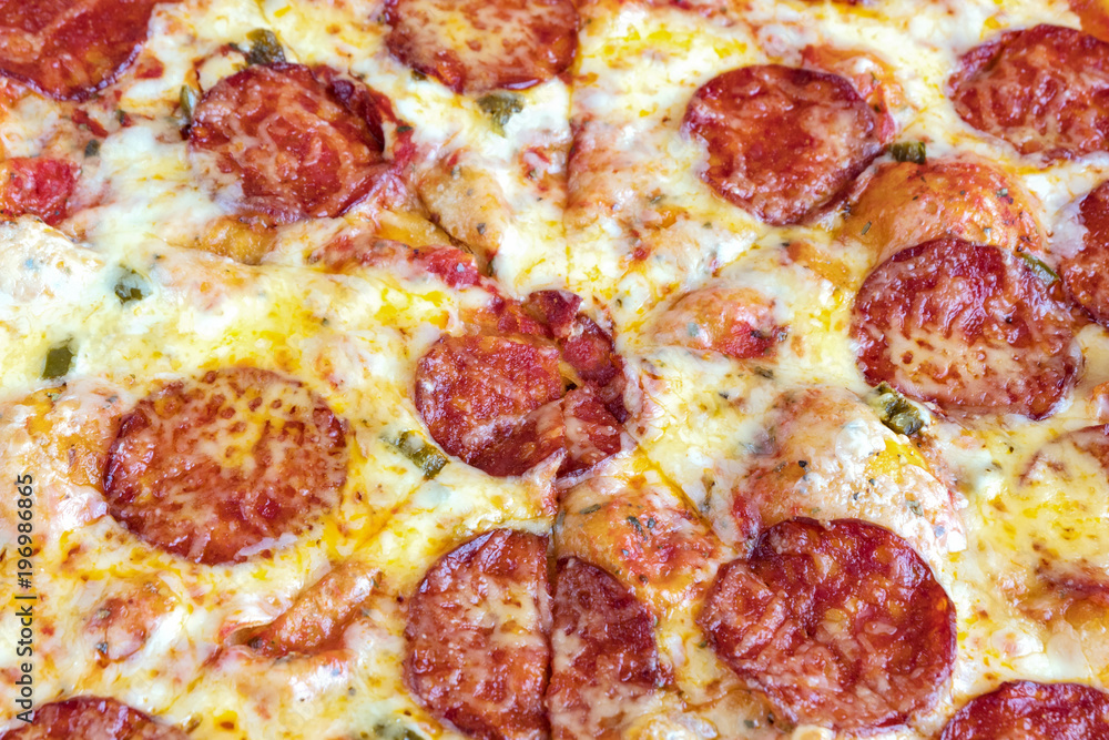 Pizza Pepperoni. Cheese and pieces of salami in close-up. Pizza Pepperoni. Cheese and pieces of salami in close-up.