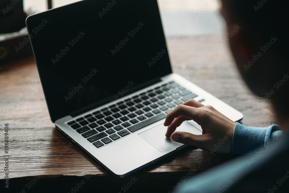Business man with laptop in a cafe Sits opposite the window Business man with laptop in a cafe Sits opposite the window