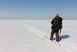 Man with a backpack is skiing on a snowy river,Ob Reservoir, Russia