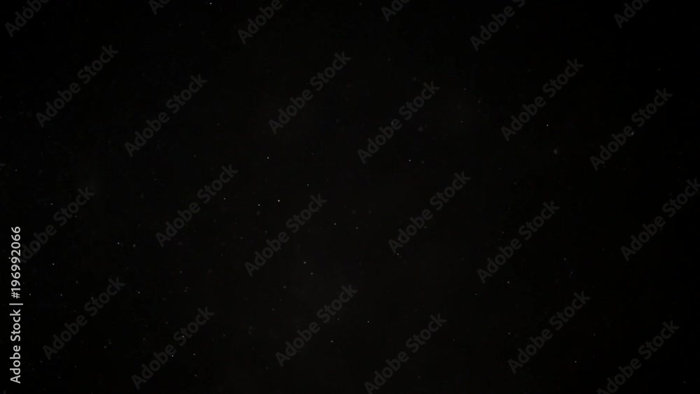 Natural organic dust particles on black background. Glittering Particles With Bokeh. Slow motion. Natural organic dust particles on black background. Glittering Particles With Bokeh. Slow motion.