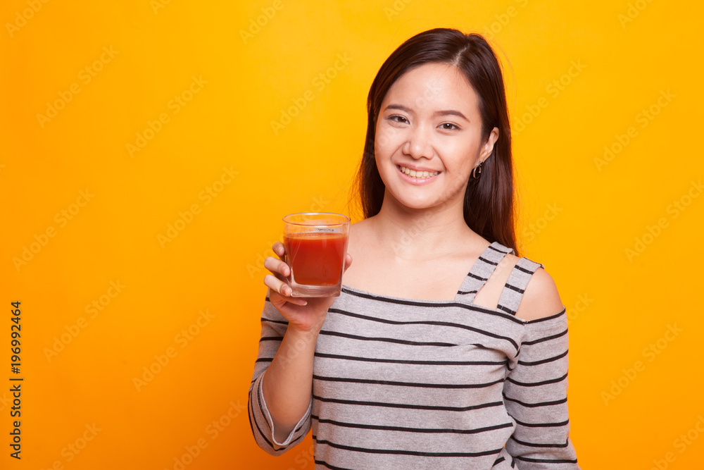 Young Asian woman drink tomato juice. Young Asian woman drink tomato juice.