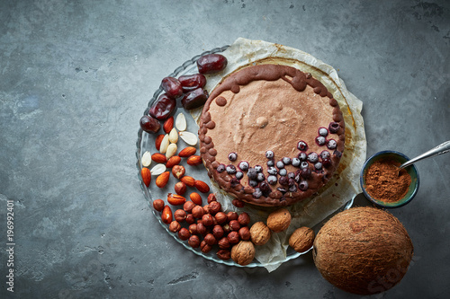 Chocolate vegan cake with different nuts, dates and carob photo