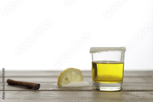 tequila shot with lemon on wood and white © jose_feito