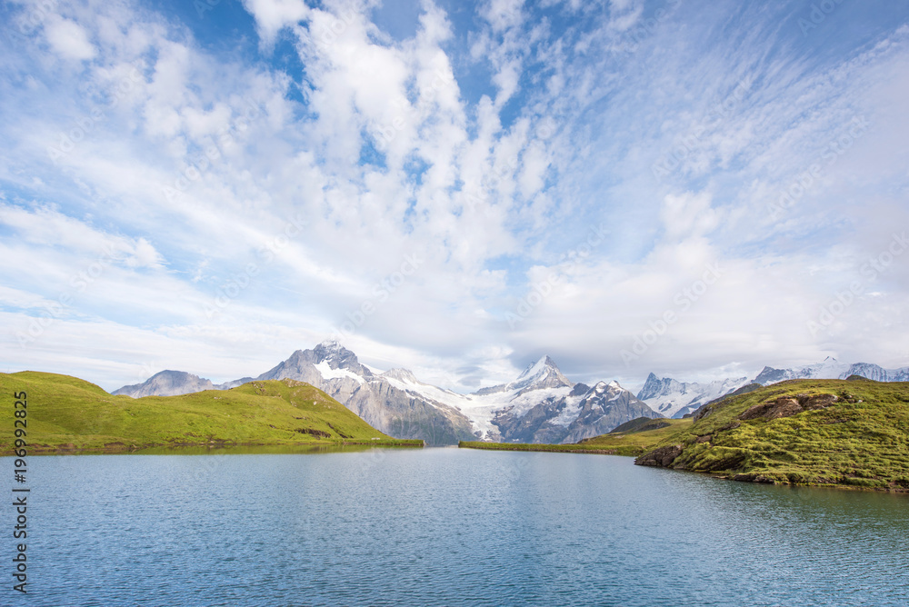 A magical landscape with a lake and clouds  in the mountains in the Swiss Alps, Europe. Wetterhorn, Schreckhorn, Finsteraarhorn et Bachsee. ( relaxation, harmony, anti-stress - concept).
