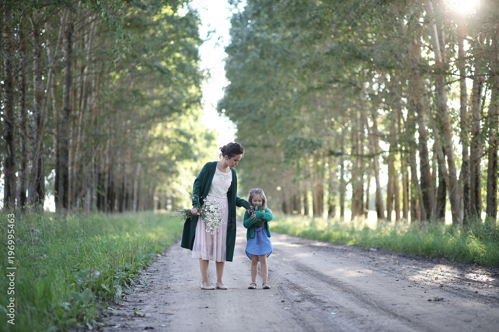 Mother with daughter walking on a road Mother with daughter walking on a road