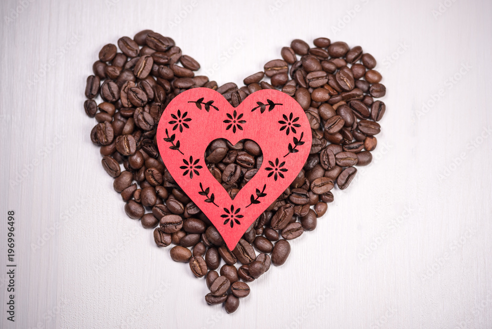Valentine Heart shape made from coffee beans on wooden surface. Valentine Heart shape made from coffee beans on wooden surface.