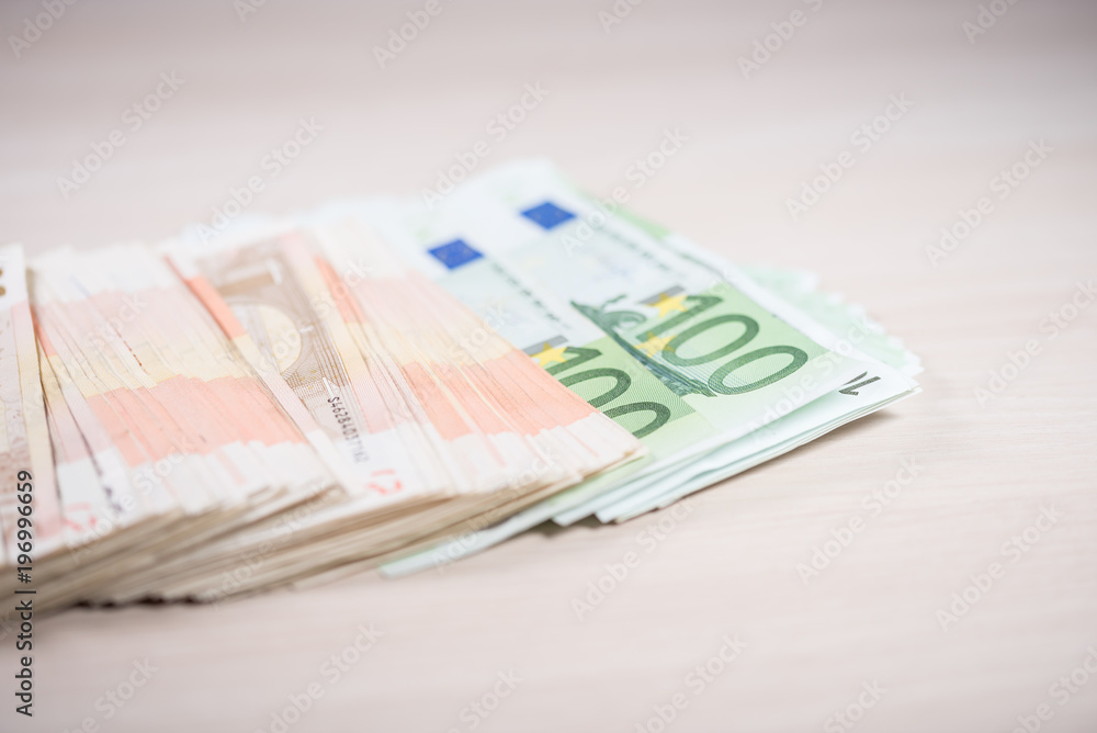 Bunch of euro banknotes on the wooden table