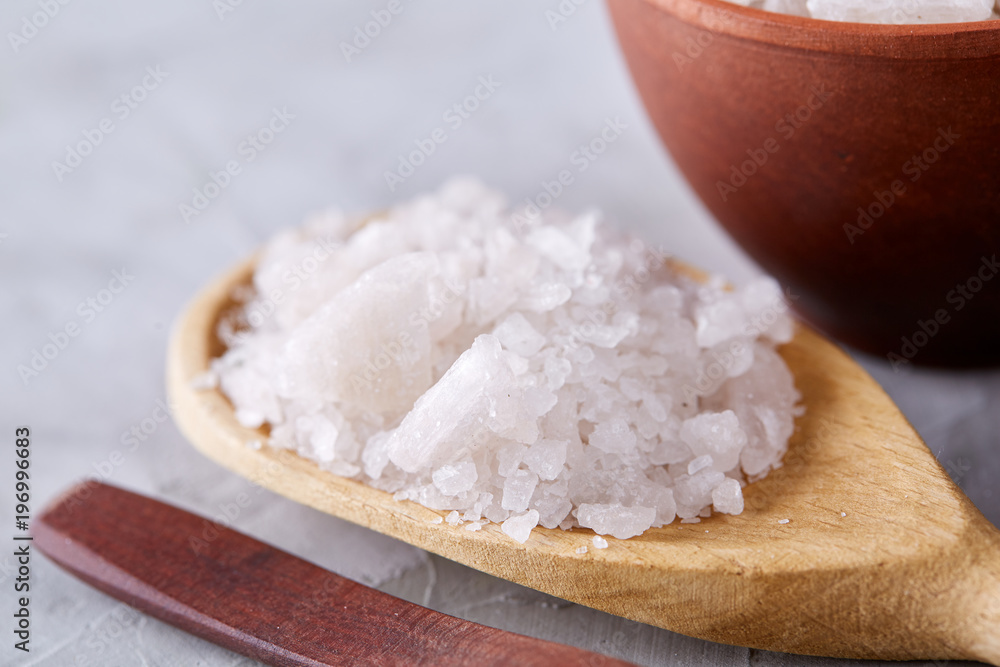 Conceptual composition of salt and pepper on spoons and bowls over light background, top view, close-up Conceptual composition of salt and pepper on spoons and bowls over light background, top view, close-up
