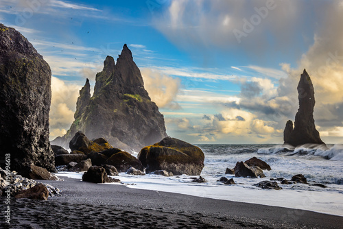 the black beach of Reynisfjara in Iceland with giant rocks and a dangerous breakwater.