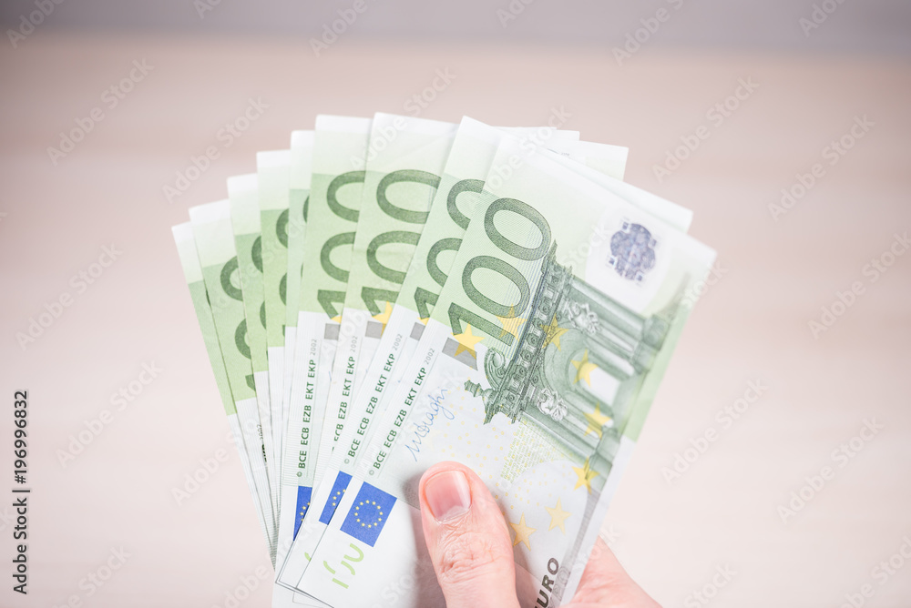 Man holding paper money - euros in the hand Man holding paper money - euros in the hand