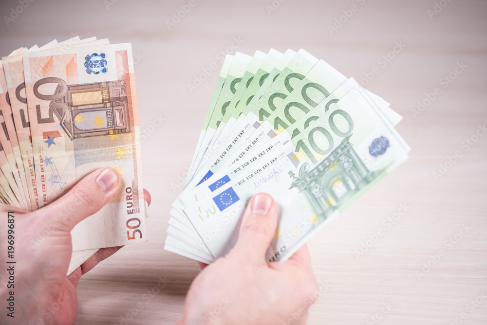 Man holding paper money - euros in the hand Man holding paper money - euros in the hand